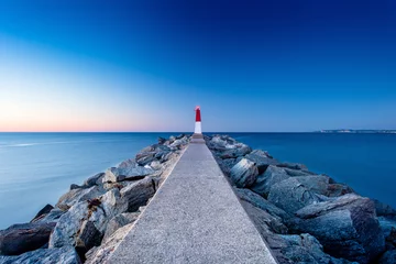 Foto op Aluminium Evening landscape with a pier and a lighthouse in Empuriabrava, Spain © axl007