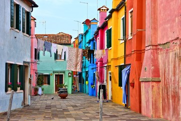 Fototapeta na wymiar Vibrant street with laundry on the colorful island of Burano near Venice, Italy