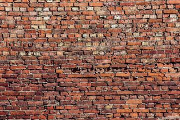 Grunge brick wall background, red cracked stones texture. Construction blocks in a line