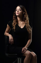 Studio shoot of beauty woman posing on the chair