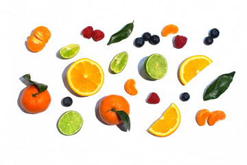 Colorful fresh fruit on white table background isolated. Orange, tangerine, lime, citrus, grapefruit. Fruit pattern. Summer food concept. Top view.