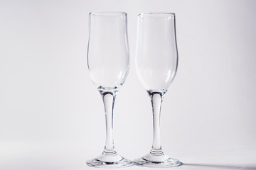 Two empty glasses on a white background
