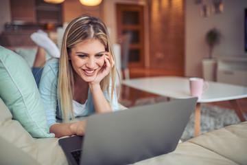 Beautiful woman at home working on laptop