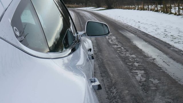 December 10th 2017. Scotland, United Kingdom. Automatic door handles and side mirror of white Tesla Model S 90D open and close