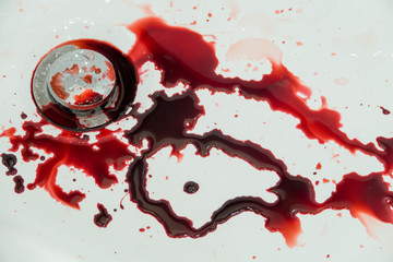 Splashes of blood dripping into the sink in the bathroom
