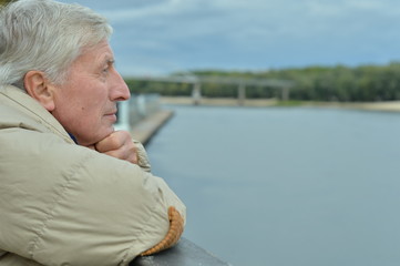 Thoughtful senior man by river