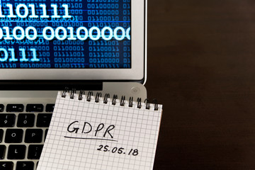 General Data Protection Regulation GDPR concept - new law in 2018 - checklist, notepad on keyboard, binary data on screen