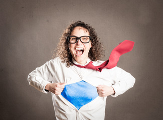 woman opening her shirt like a superhero on a gray background