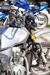 Fototapeta na wymiar Motorcycles, in the foreground a fragment of a motorcycle, in the background a second motorcycle.