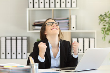 Excited businesswoman celebrating success at office