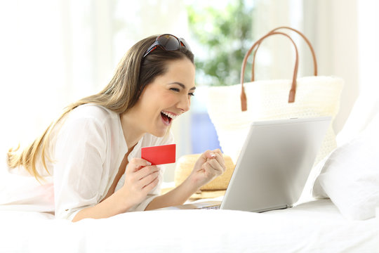 Excited woman buying online in vacations