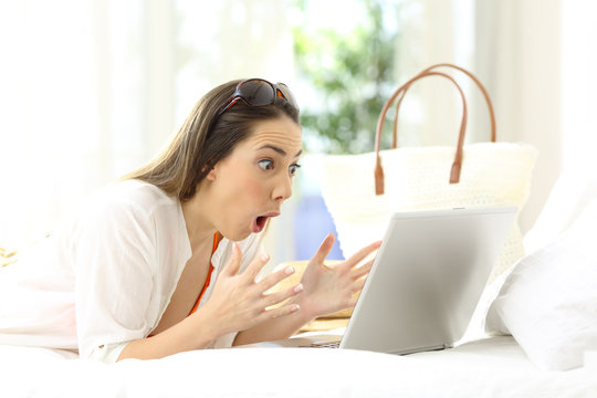 Excited woman reading online content on vacations