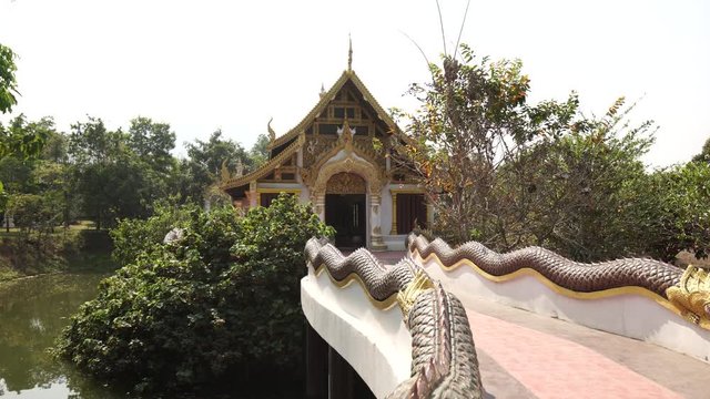 Panorama along the beautiful dragon bridge in the Buddhist temple. Asian temple landscape. Dolly shot