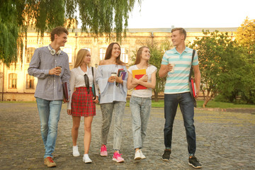 Group of young students walking near university building