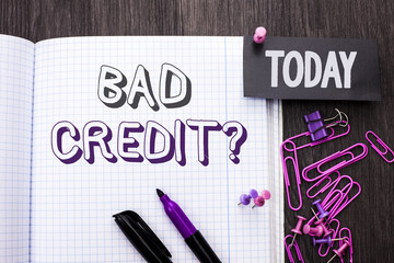 Handwriting text Bad Credit Question. Concept meaning Low Credit Finance Economic Budget Asking Questionaire written on Notebook Book on wooden background Today with Thumbpin Marker Paper Clip.