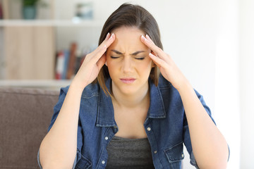 Woman complaining suffering migraine at home