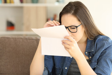 Woman having eyesight problems to read a letter