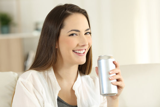 Woman holding a refreshment can looking at you