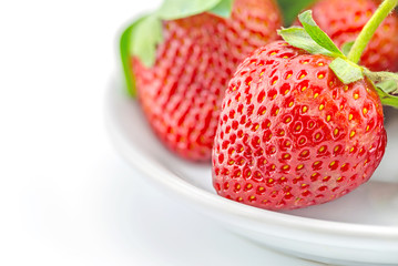 fresh strawberries on plate on white background