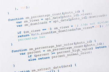 Web developer programming code printed on a piece of paper