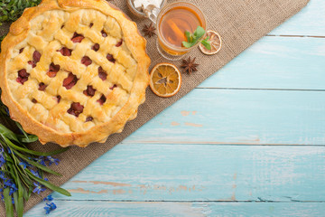 Homemade pie with flowers on a wooden background. With an empty place for the inscription.