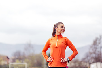 Portrait of active young woman preparing to run