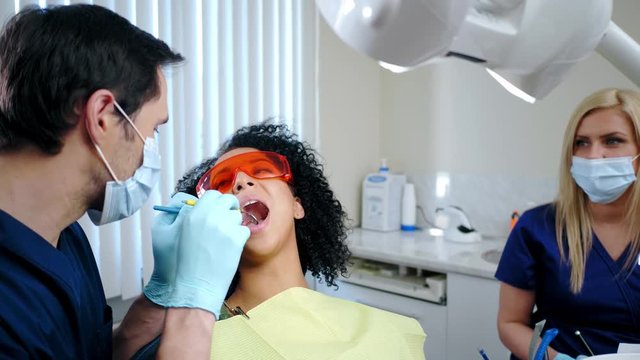 Dentist and his assitant working in private practice.
