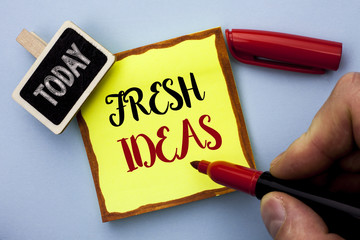 Word writing text Fresh Ideas. Business concept for Creative Vision Thinking Imagination Concept Strategy  written by Man Holding Marker on Sticky Note Paper on the plain background Today