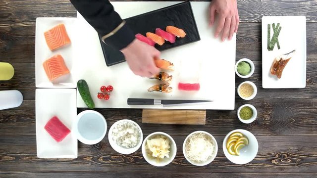 Hands of chef, sushi. Cooking table, traditional japanese food.