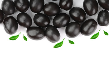 whole black olives decorated with leaves isolated on white background with copy space for your text. Top view. Flat lay