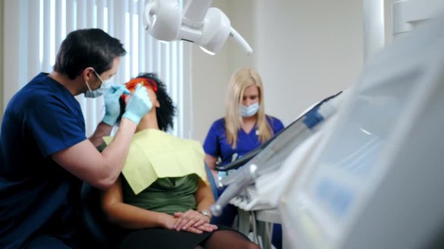 Dentist and his assitant working in private practice.