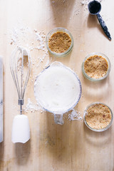 Preparation of a cheesecake on jar without baking it, biscuit mixed with butter are pressed in glass container