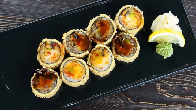 Unagi maki rolls top view. Sushi plate on wooden background.