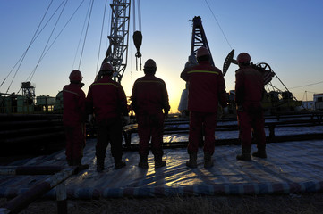 Oil field oil workers at work