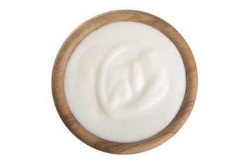 yogurt in a wooden bowl isolated on white background top view