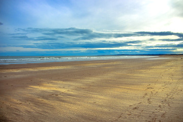 Obraz premium Beach and sea background. St Cyrus, Aberdeenshire, Scotland, UK.