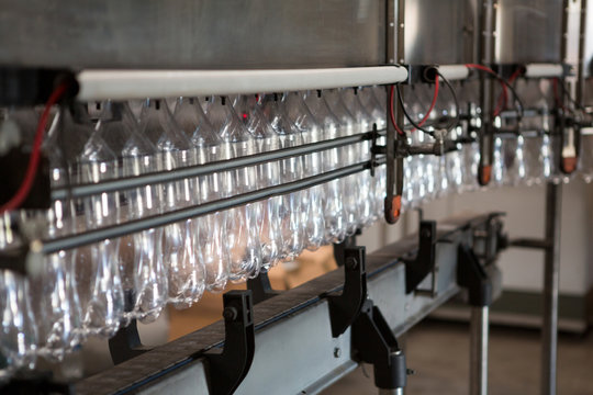 Empty bottles on production line in cold drink factory