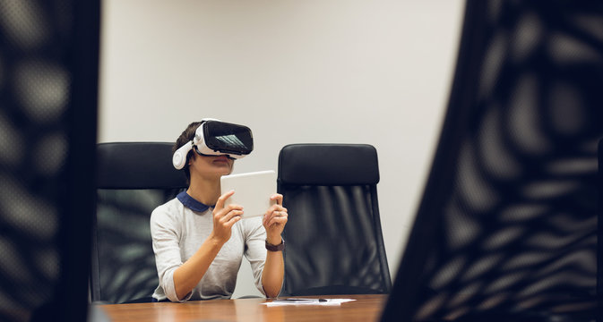 Businesswoman using virtual reality headset