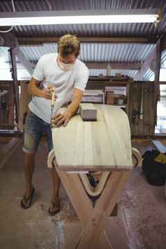 Man making surfboard