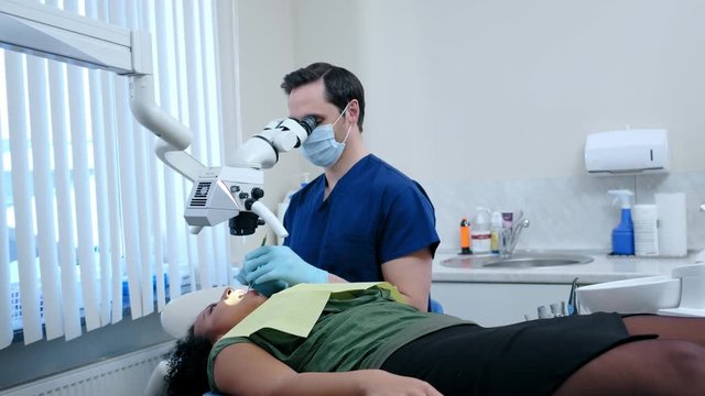 Man dentist and his pacient in private practice.