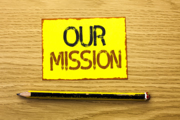 Conceptual hand writing showing Our Mission. Business photo showcasing Goal Motivation Target Growth Planning Innovation Vision written on Yellow Sticky Note on wooden background Pencil.