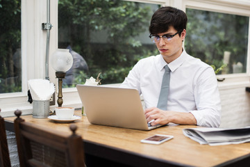 Businessman working on laptop in office