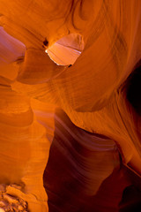 Lower Antelope Canyon window of light in orange send underground world in Arizona