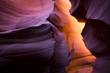 The meandering walls of the underground labyrinth of colored sand of the Lower Antelope Canyon in...
