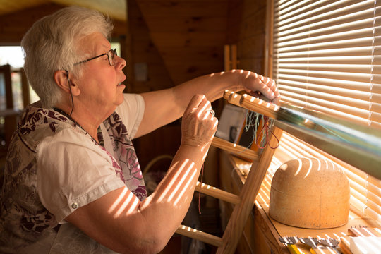 Senior woman weaving silk at shop