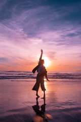 Woman dancing at the sunset