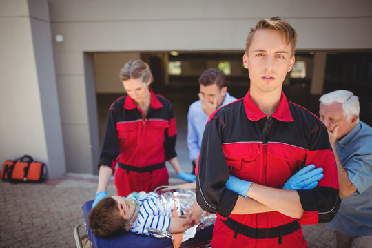 Paramedics examining injured boy