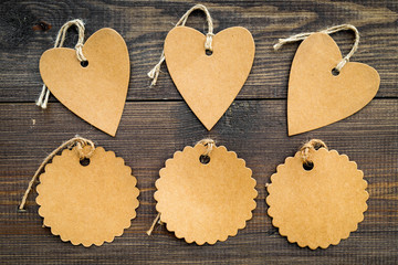 Figured blank tags for write price or discount on dark wooden background mockup pattern