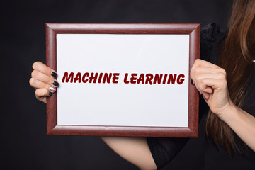 In the hands of a businessman a frame with the inscription:MACHINE LEARNING