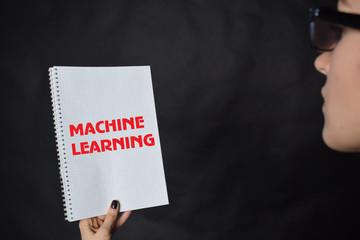 In the hands of a businessman a notebook with the inscription:MACHINE LEARNING